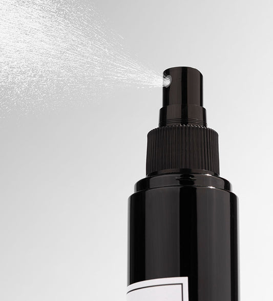 A black bottle of LAVENDER VANILLA room spray with a white label