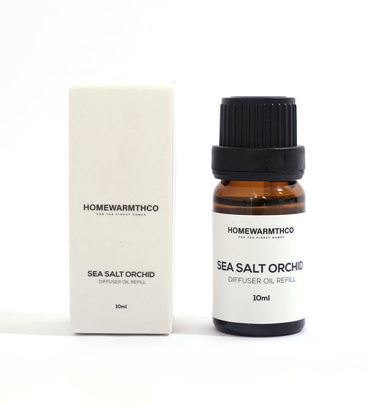 A small brown bottle with a black cap labeled 'Sea Salt Orchid Diffuser Oil