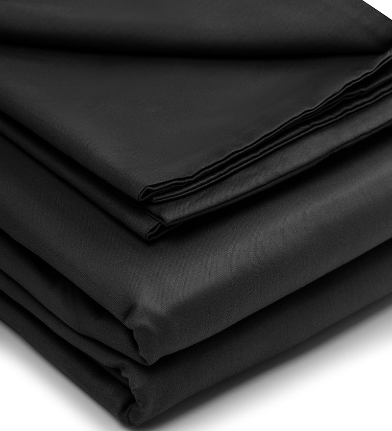 A set of black duvet covers folded on a white background.