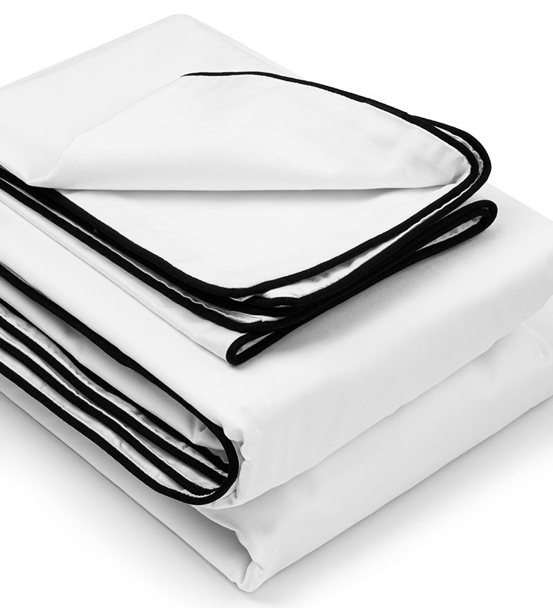 A white duvet cover set with black binding