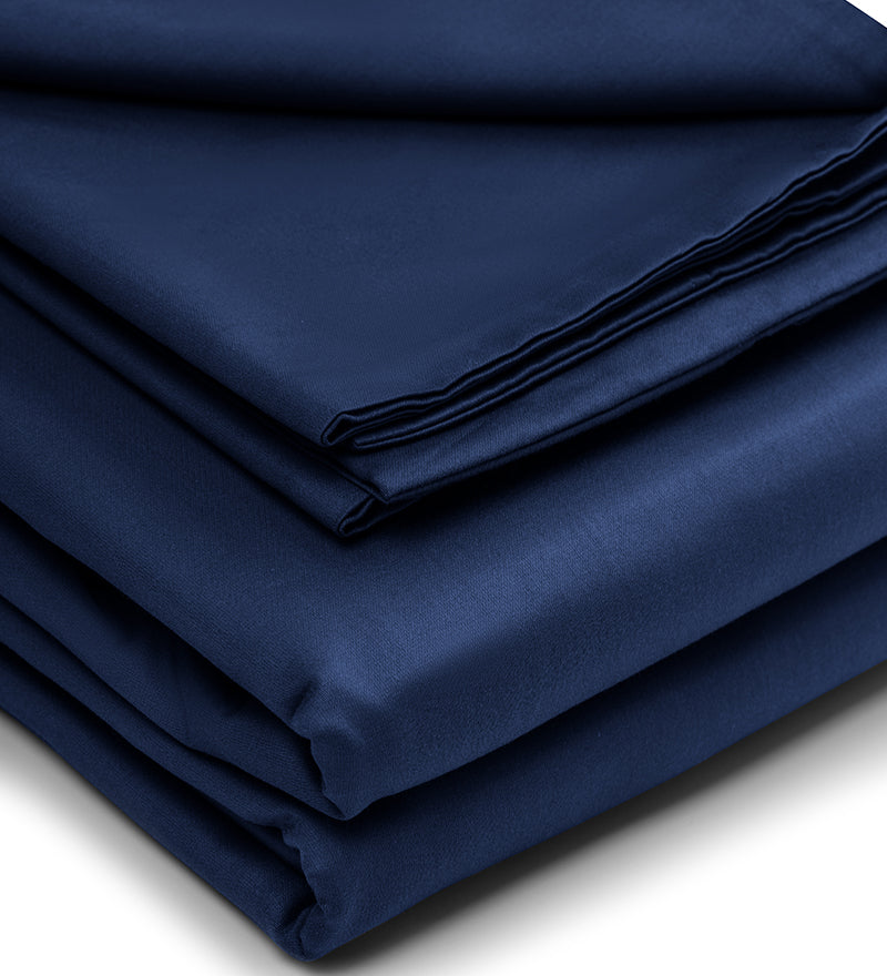 A set of navy and white patterned duvet cover folded at a white background
