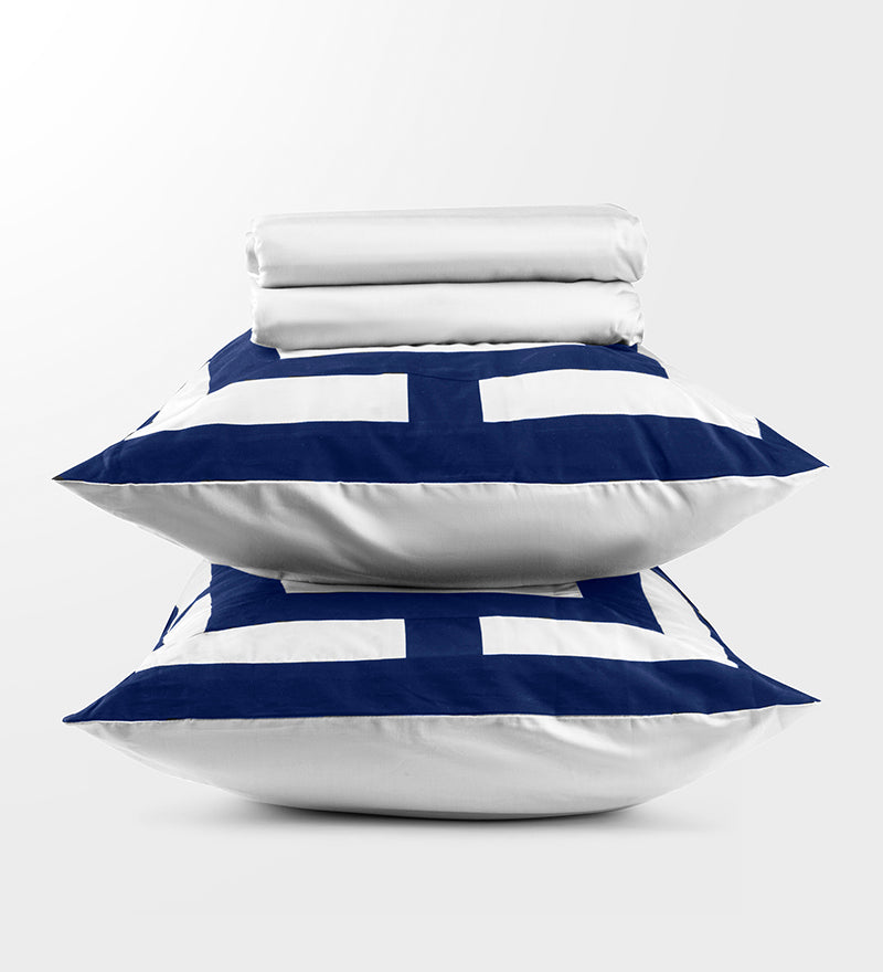 A set of navy and white patterned duvet covers displayed on a pillows