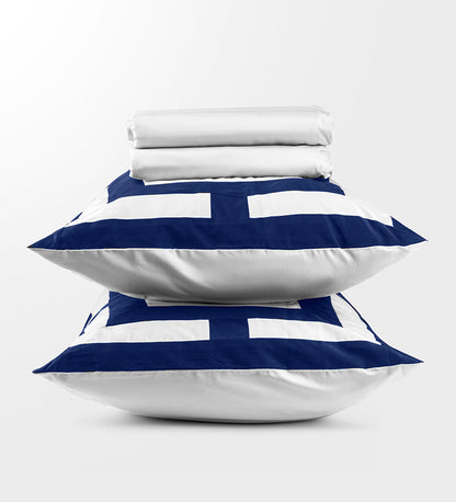 A set of navy and white patterned duvet covers displayed on a pillows
