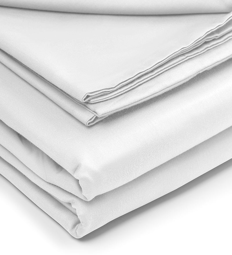A set of white duvet covers displayed on a bed