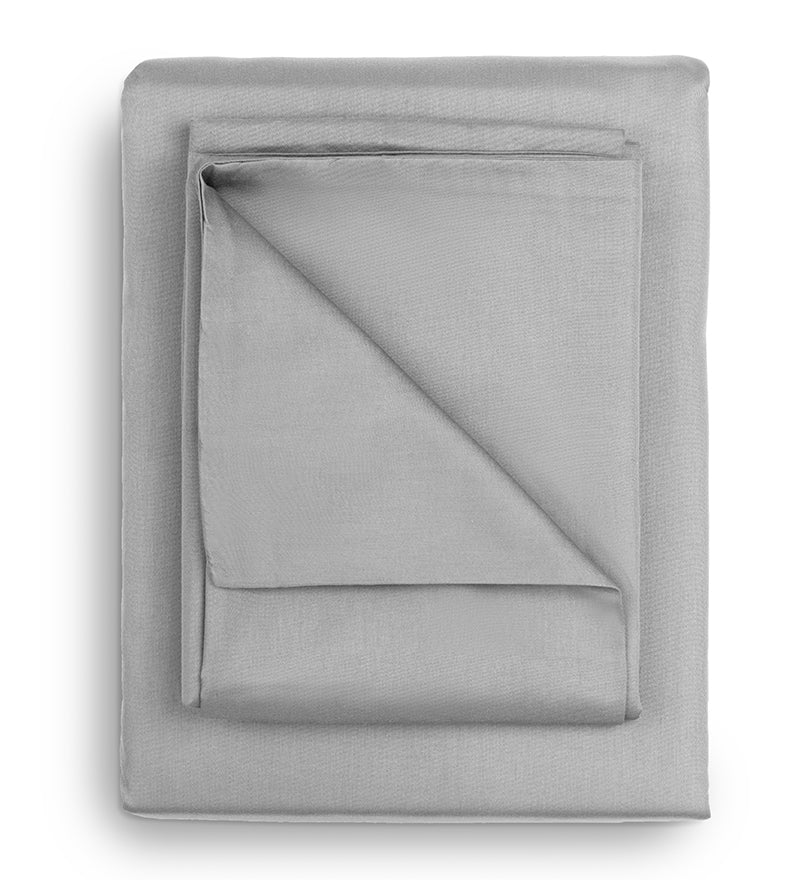A set of grey duvet covers displayed on a bed with two pillows