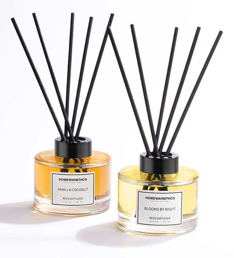 A reed diffuser set, with a clear bottle containing oil and black reeds