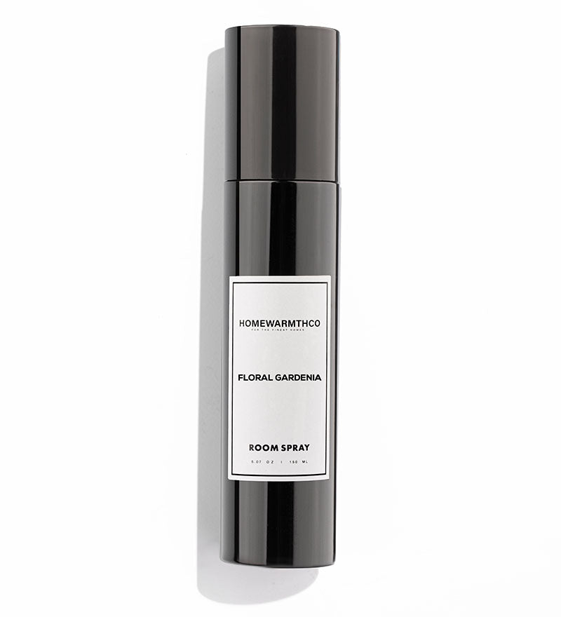 A black bottle of Floral Gardenia room spray with a white label