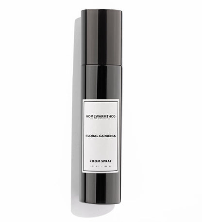 A black bottle of Floral Gardenia room spray with a white label