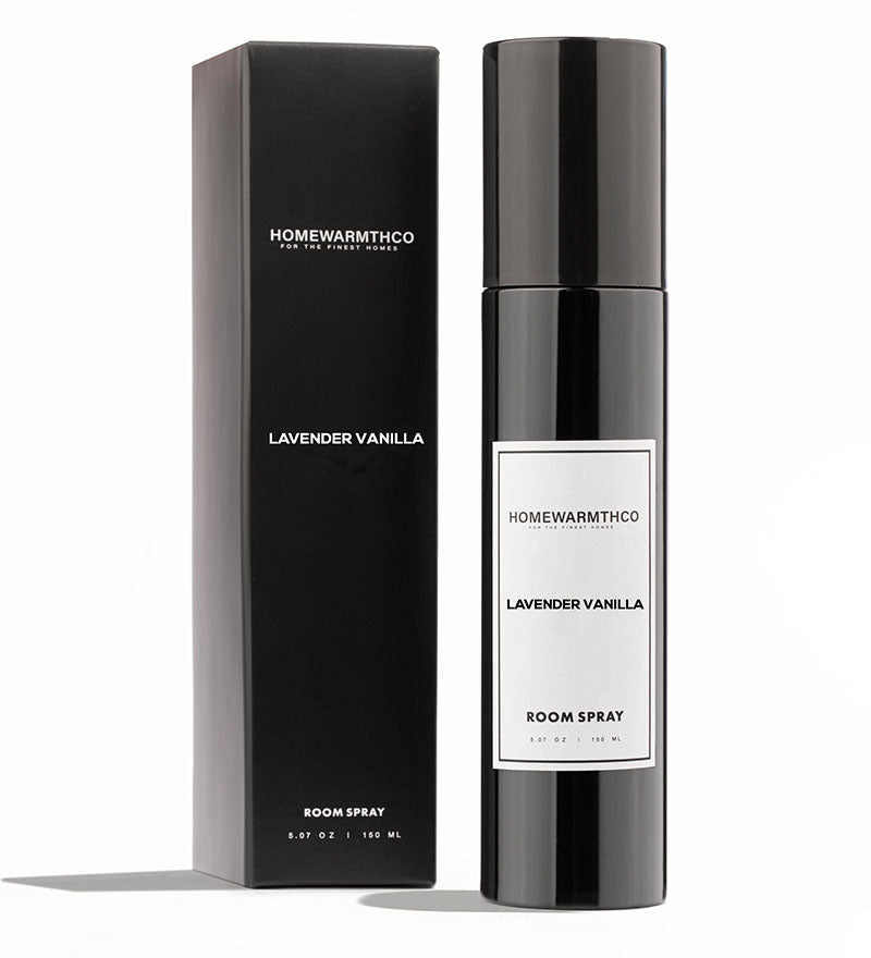 A black bottle of LAVENDER VANILLA room spray with a white label, placed next to its black box packaging with the same label.