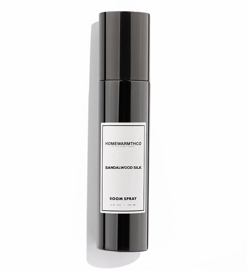 A black bottle of SANDALWOOD SILK room spray with a white label