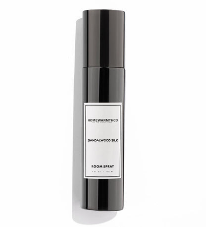 A black bottle of SANDALWOOD SILK room spray with a white label
