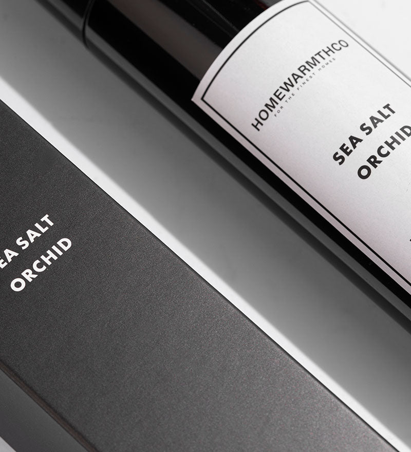 A black bottle of Sea Salt Orchid room spray with a matching box