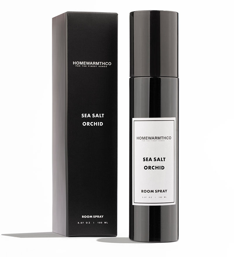 A black bottle of Sea Salt Orchid room spray with a matching black box behind it. The label on the bottle and box reads 'Home Fragrances' and 'Sea Salt Orchid'.