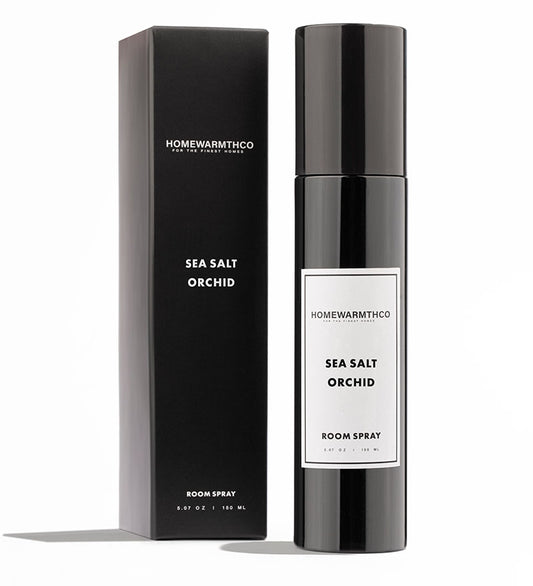 A black bottle of Sea Salt Orchid room spray with a matching black box behind it. The label on the bottle and box reads 'Home Fragrances' and 'Sea Salt Orchid'.