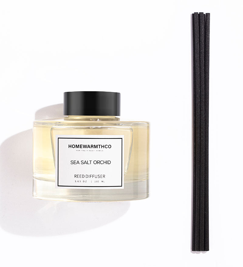 A luxury reed diffuser from HomeWarmthCo with black reeds