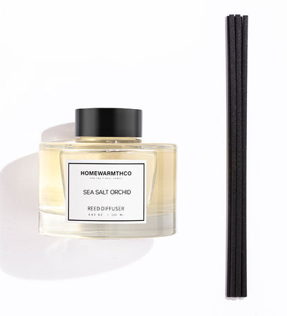A luxury reed diffuser from HomeWarmthCo with black reeds