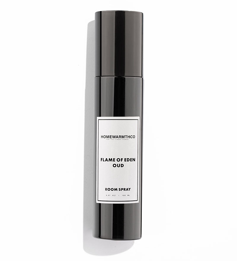 A black bottle of Flame of Eden Oud room spray with a white label