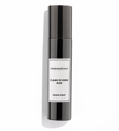 A black bottle of Flame of Eden Oud room spray with a white label