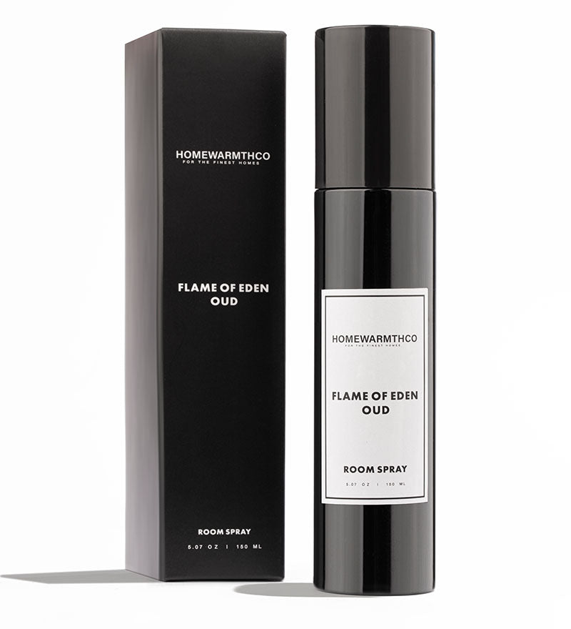 A black bottle of Flame of Eden Oud room spray with a white label, placed next to its black box packaging with the product name and brand visible.