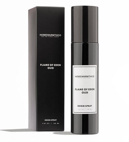 A black bottle of Flame of Eden Oud room spray with a white label, placed next to its black box packaging with the product name and brand visible.