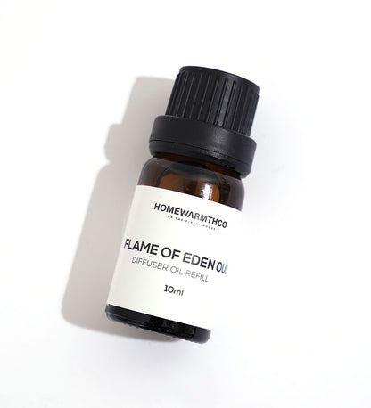 A small dark-colored bottle labeled 'Flame of Eden Oud Diffuser Oil'