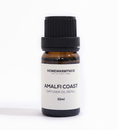 A small dark brown bottle with a black cap labeled 'Amalfi Coast Diffuser Oil Refill 10ml' by Homewarmthco.