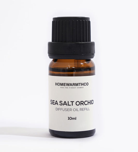 A small brown bottle with a black cap labeled 'Sea Salt Orchid Diffuser Oil Refill 10ml' from HomeWarmthCo.