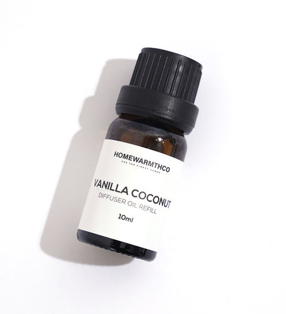 A small dark-colored bottle labeled 'VANILLA COCONUT'