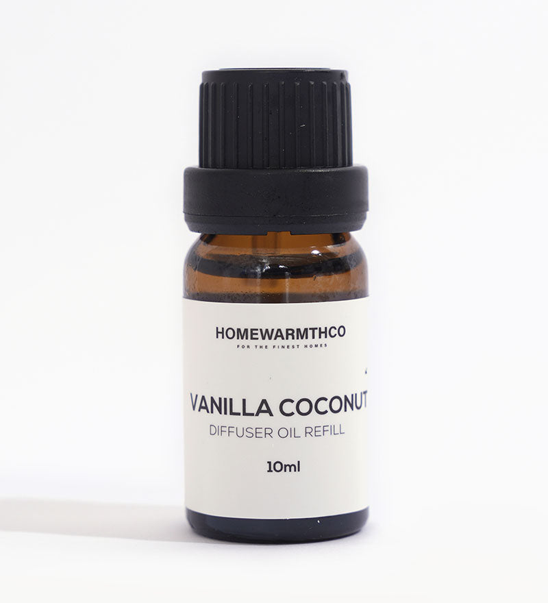 A small dark-colored bottle labeled 'VANILLA COCONUT' indicates it is a diffuser essential oil.