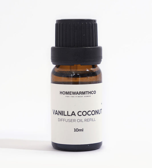A small dark-colored bottle labeled 'VANILLA COCONUT' indicates it is a diffuser essential oil.