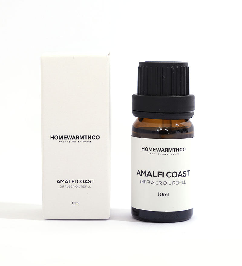 A small dark brown bottle with a black cap labeled 'Amalfi Coast Diffuser Oil 